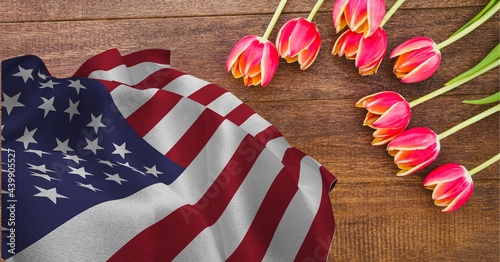 American flag and pink tulip flowers on wooden background