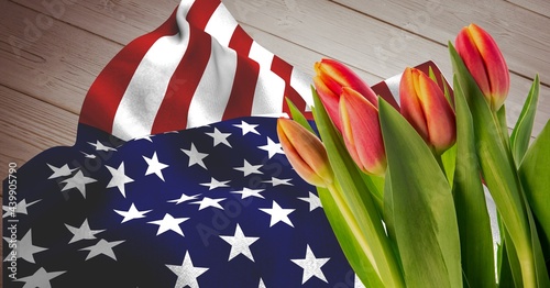 American flag and pink red tulip flowers on wooden background