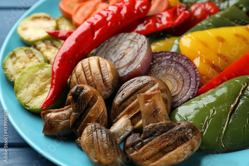 Delicious grilled vegetables on blue plate, closeup