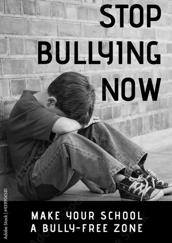 Composition of anti bullying text with crying schoolboy in black and white