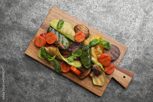 Delicious grilled vegetables on grey table, top view
