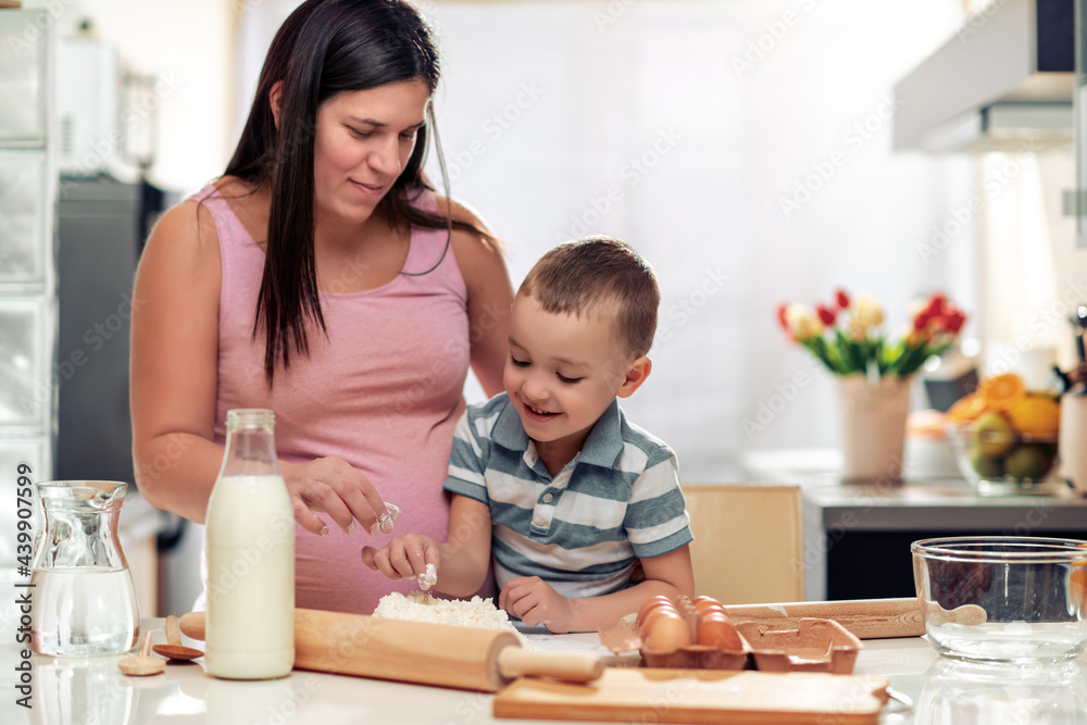 Mom and son have fun in the kitchen