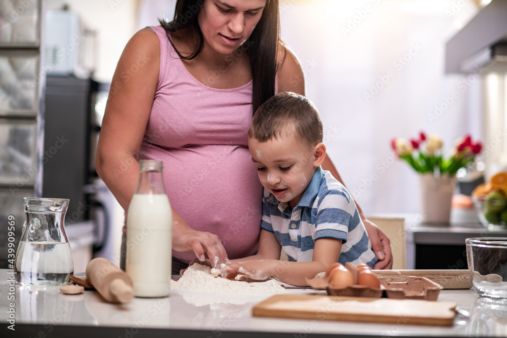 Family cooking together in modern home kitchen Family cooking together in modern home kitchen