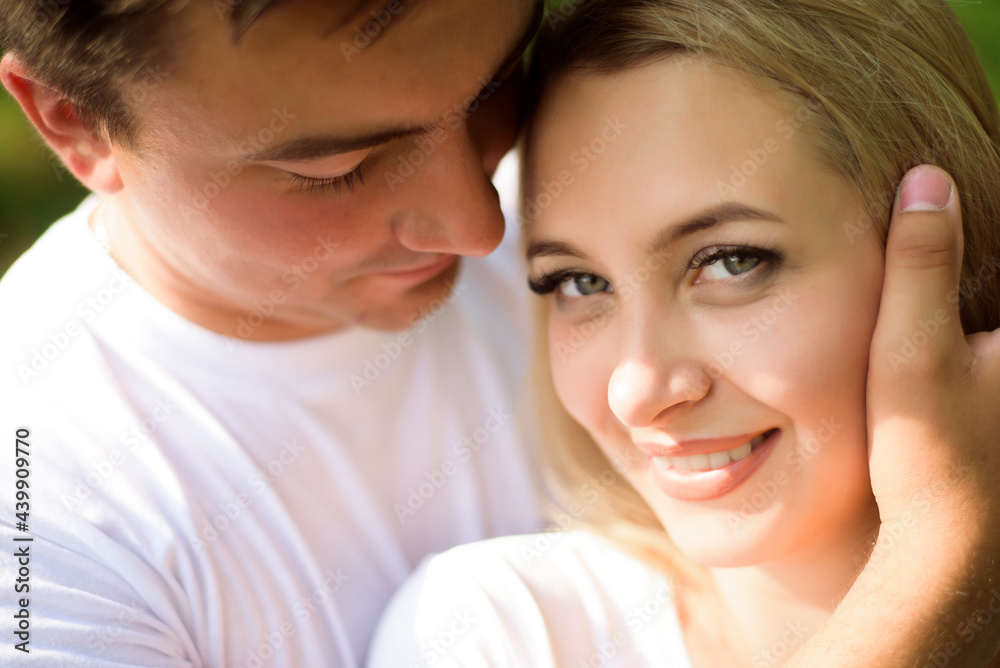 Young beautiful couple hand by hand on natural background. Young beautiful couple hand by hand on natural background.