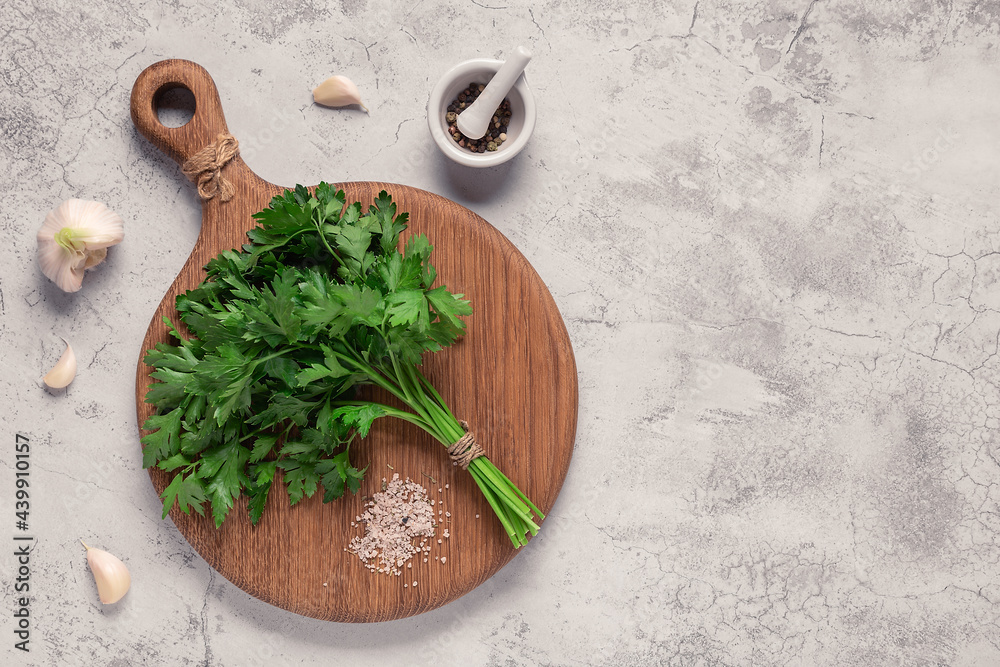cutting board, parsley on a concrete table cutting board, parsley on a concrete table