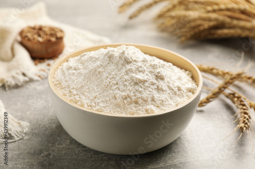 Bowl of flour on light grey table, closeup