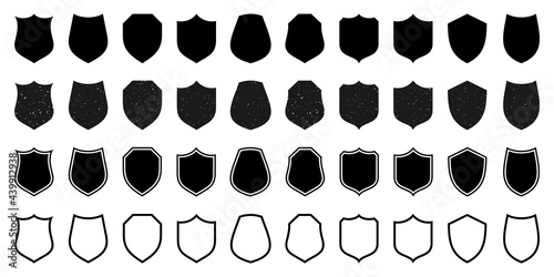 Set of various vintage outlined shield icons. Black heraldic shields with grunge texture. Protection and security symbol, label. Vector illustration.