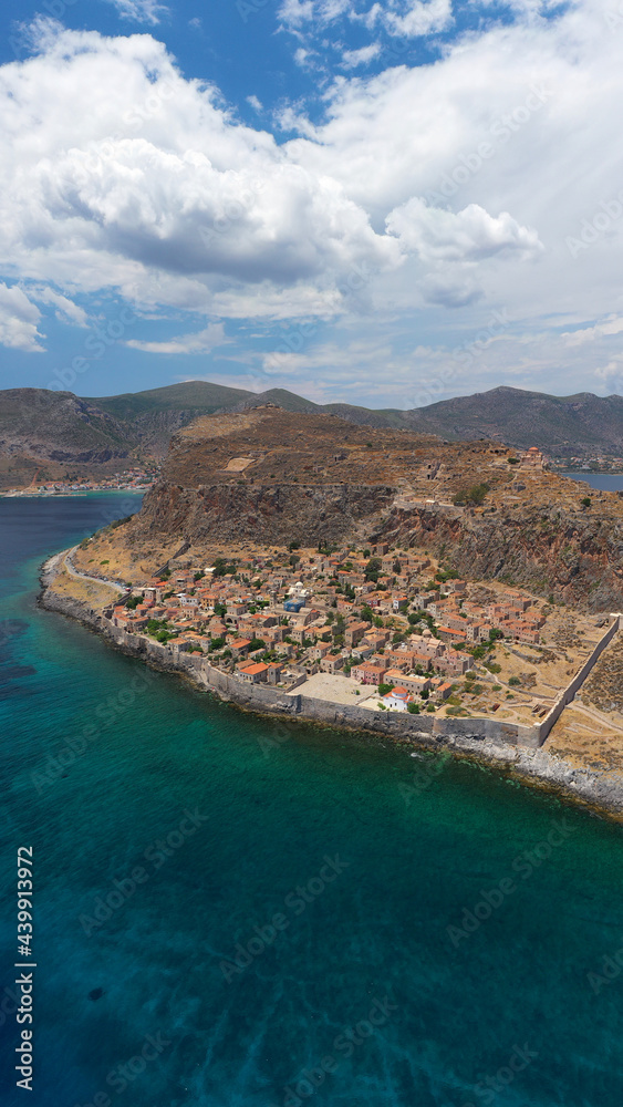 Aerial drone photo of beautiful castle and medieval old city of Monemvasia in the heart of Lakonia with beautiful clouds and deep blue sky, Peloponnese, Greece