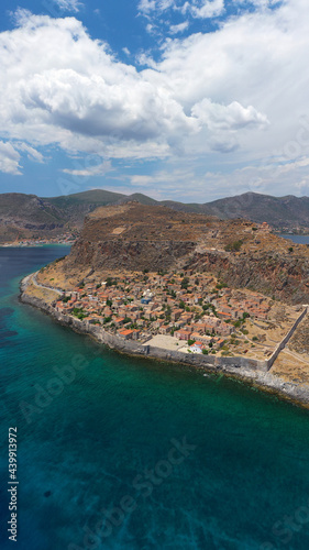 Aerial drone photo of beautiful castle and medieval old city of Monemvasia in the heart of Lakonia with beautiful clouds and deep blue sky, Peloponnese, Greece