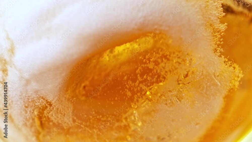 Super Slow Motion Detail Shot of Pouring Beer into Glass at 1000fps.