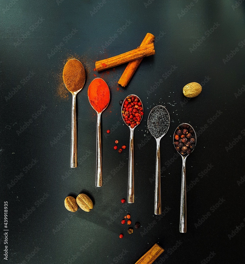 Colorful condiments in five teaspoons Colorful condiments in five teaspoons