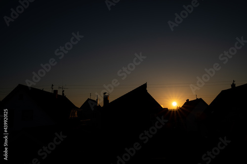 Sunrise over the roofs of the village