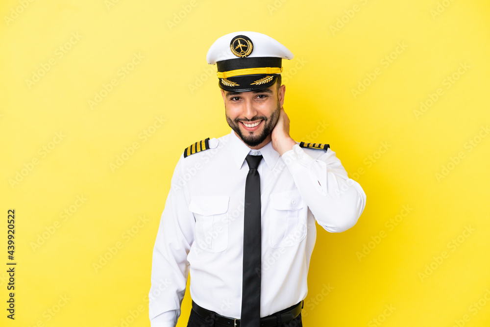 Airplane arab pilot man isolated on yellow background laughing Airplane arab pilot man isolated on yellow background laughing