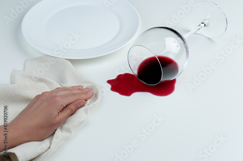 Woman cleaning spilled wine on white background, closeup