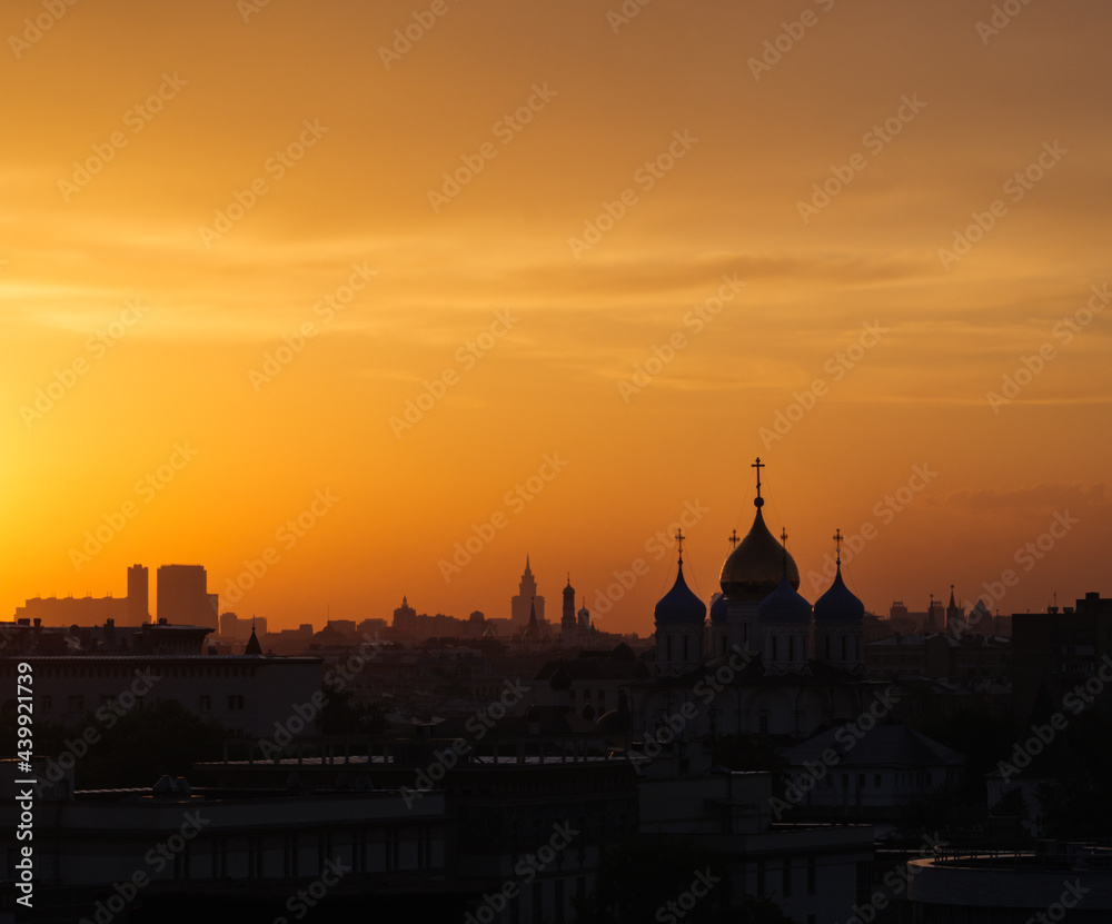 Silhouette of temple and the city at orange sunset