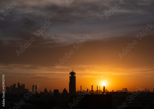 Orange sunset and silhouette of the city