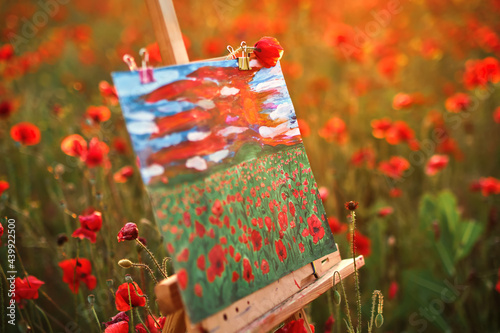 easel with canvas painting in the field