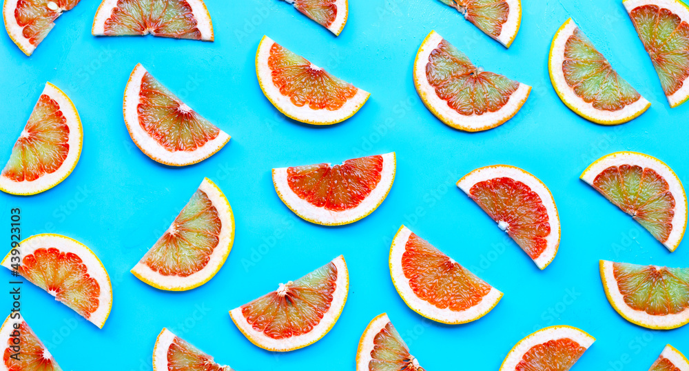 High vitamin C. Juicy grapefruit slices on blue background. Top view High vitamin C. Juicy grapefruit slices on blue background. Top view