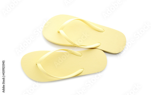 Stylish yellow flip flops on white background, top view photo