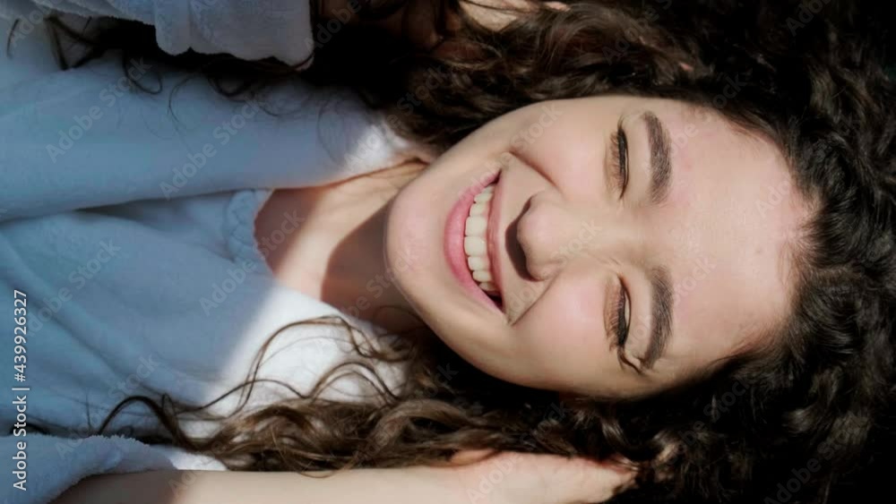 Portrait of pretty healthy cheerful joyful curly haired girl looking at camera with charming smile and having fun. Portrait of pretty healthy cheerful joyful curly haired girl looking at camera with charming smile and having fun.