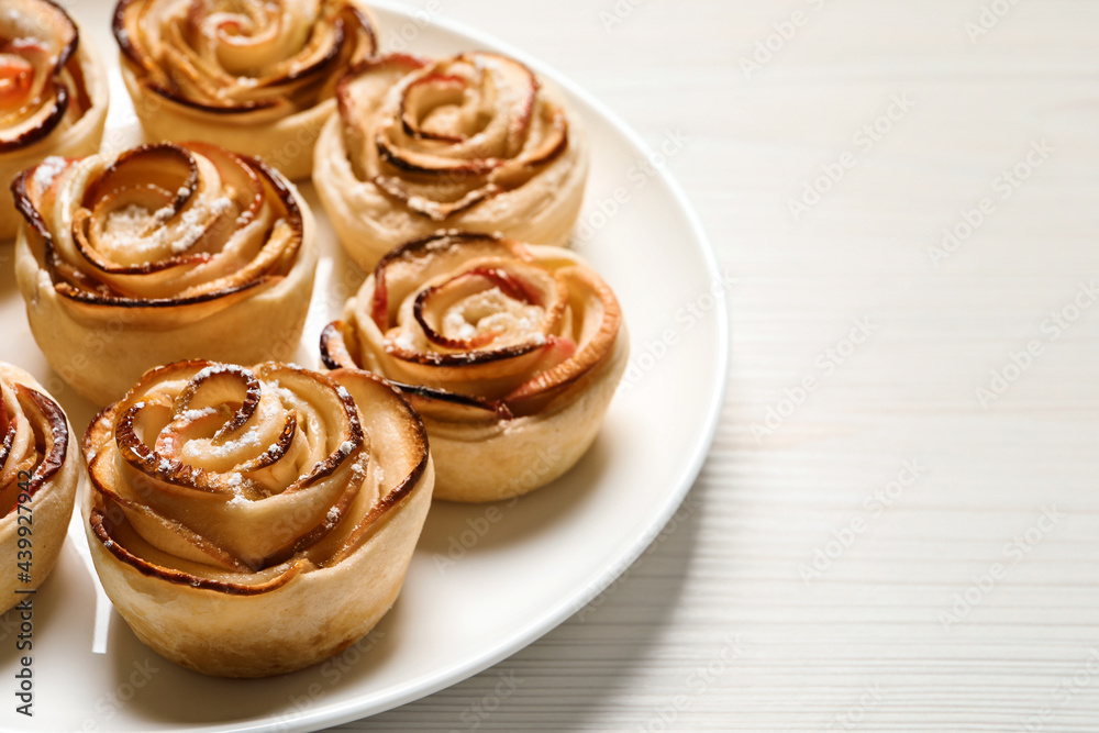 Freshly baked apple roses on white wooden table, space for text. Beautiful dessert Freshly baked apple roses on white wooden table, space for text. Beautiful dessert
