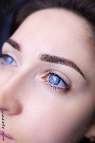 close-up of a girl's eyebrows with permanent makeup