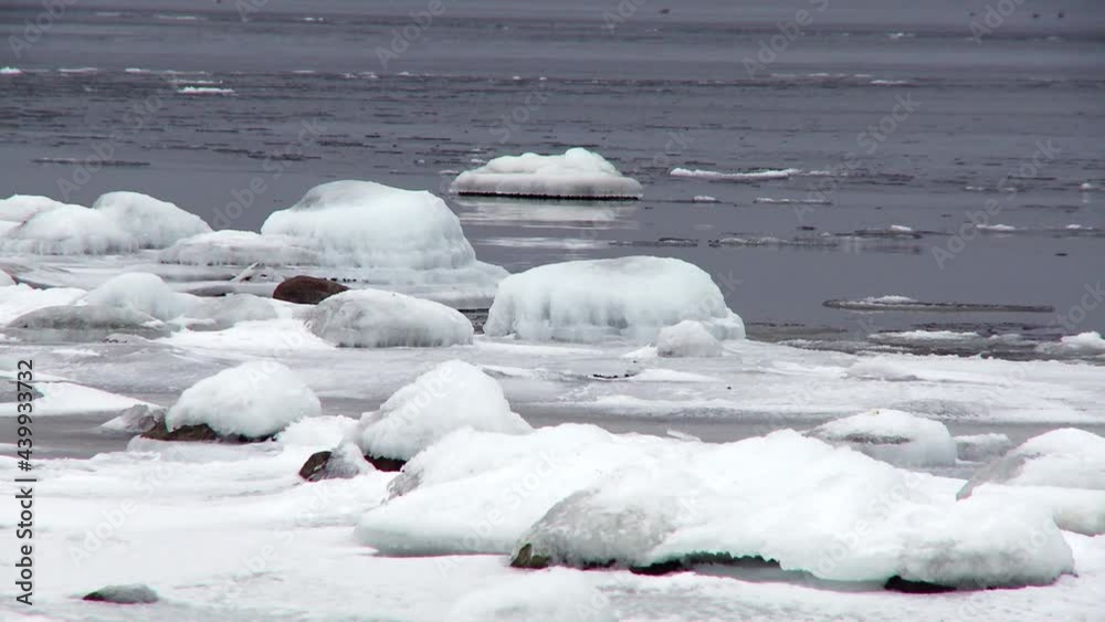 Waves breaking into a ice coverd beach