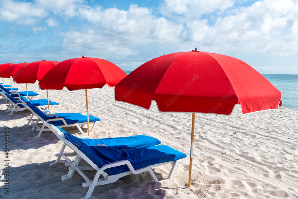 Sun and sea. Sunloungers and beach umbrellas in Miami, USA. Beach furniture. Summer vacation