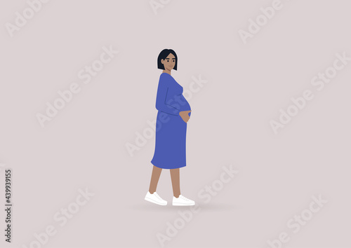 A young pregnant woman wearing a simple blue dress and white sneakers, modern lifestyle