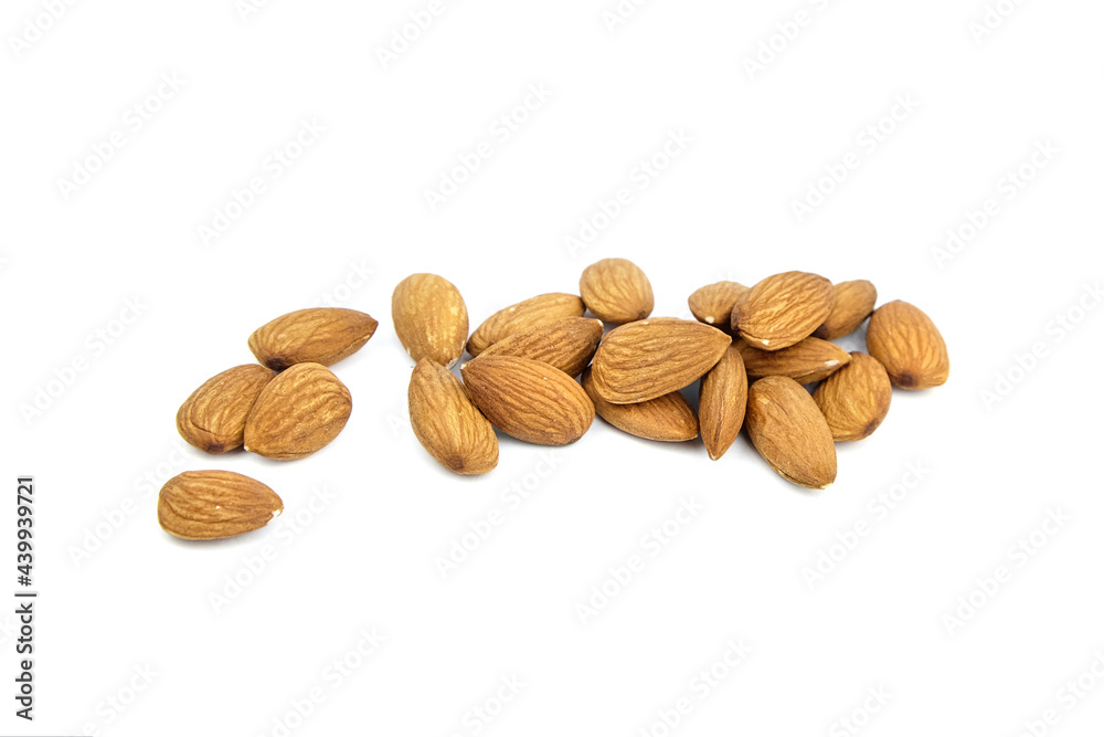Almond nuts isolated on white background. Heap of scattered almonds Almond nuts isolated on white background. Heap of scattered almonds