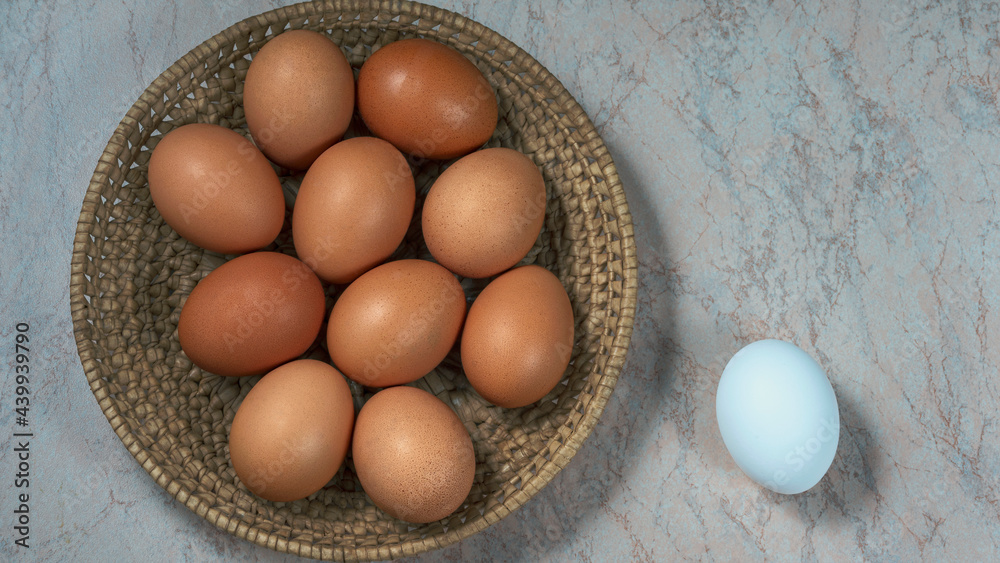 several fresh chicken eggs in a straw basket on a wooden background. Healthy eating concept. several fresh chicken eggs in a straw basket on a wooden background. Healthy eating concept.