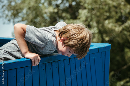 A little boy walks and plays in the park. photo