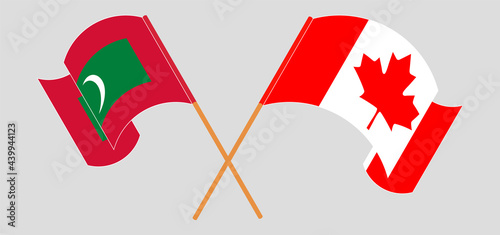 Crossed and waving flags of Maldives and Canada