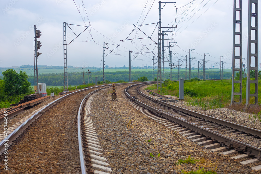 Railway tracks with a turn on the background of nature in summer. Road for travel and tourism