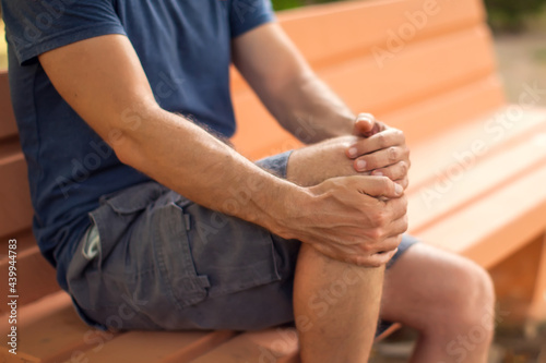 Man with knee pain outdoor. Healthcare and medicine concept