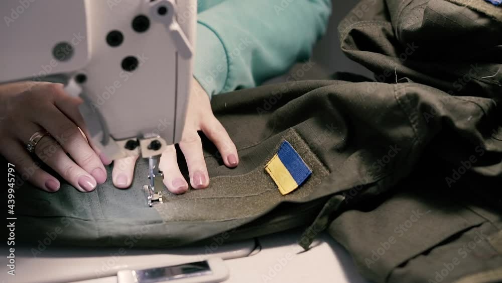 Sew. A woman sews a Ukrainian military uniform on a sewing machine. Closeup. Stock Video