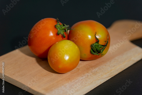 Fresh tomatoes on a wooden board