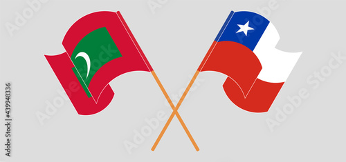 Crossed and waving flags of Maldives and Chile