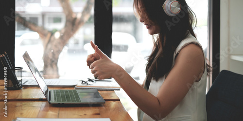 Tableau sur toile Young woman gammer or blogger influencer sit looking at camera make video conference call recording vlog in living room at her home
