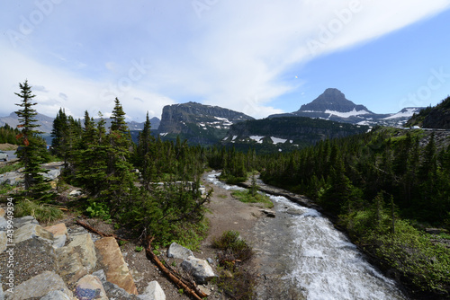 Wide angle view of a flowing river and mountains in the background at Glacier National Park in Montana