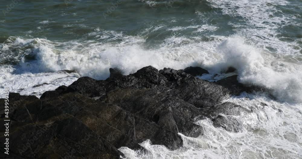 Waves splashing on rocks. Le Pouldu, Finistere department, Brittany, France Waves splashing on rocks. Le Pouldu, Finistere department, Brittany, France