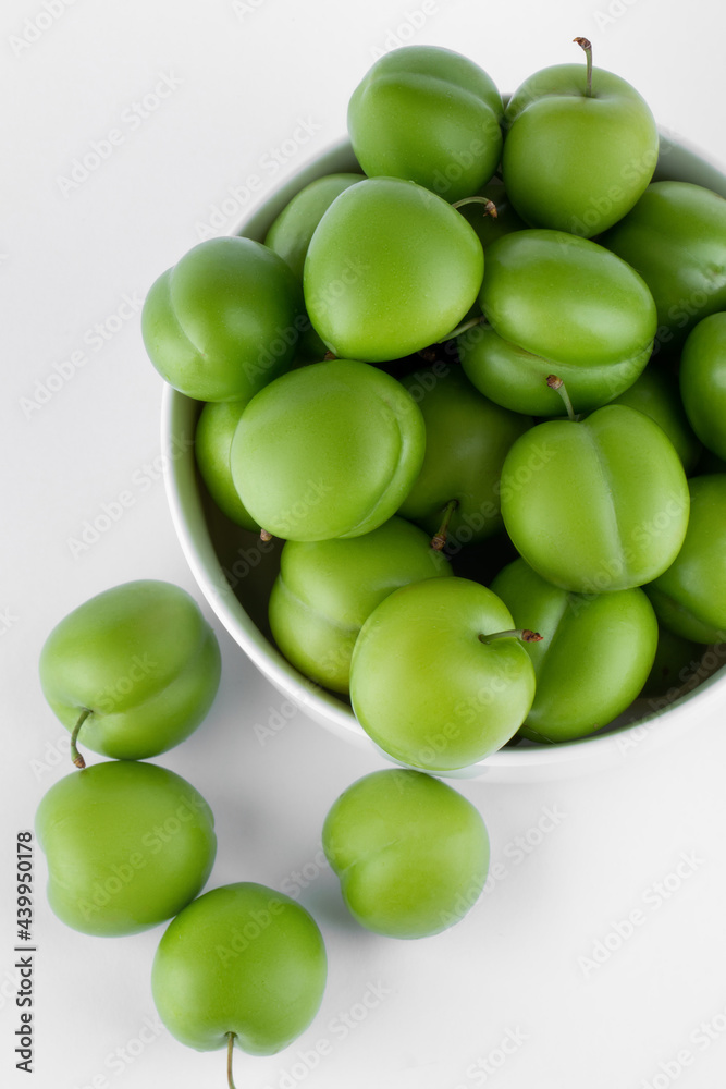 fresh and green plum on white background