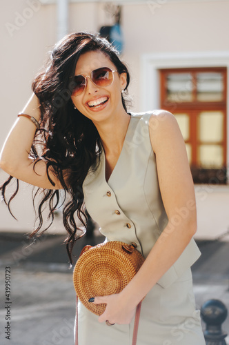 portrait of a beautiful young woman 29 years old with dark long hair on a summer day in sunglasses.