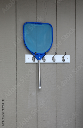 Nautical blue skimming net hung on a peg