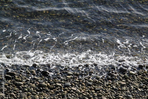 Gentle ocean waves meeting the rocky shore