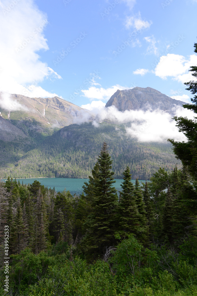 Scenic view of mountains, trees and a lake at Glacier National Park in Montana