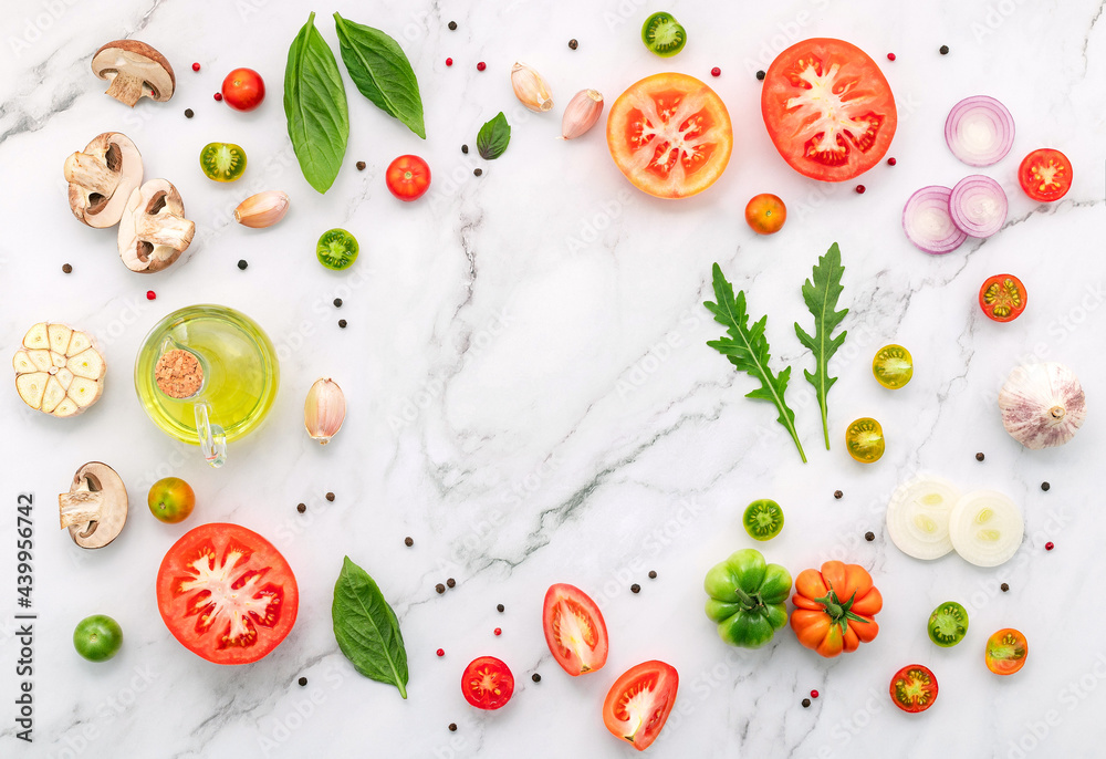 The ingredients for homemade pizza set up on white marble background. The ingredients for homemade pizza set up on white marble background.