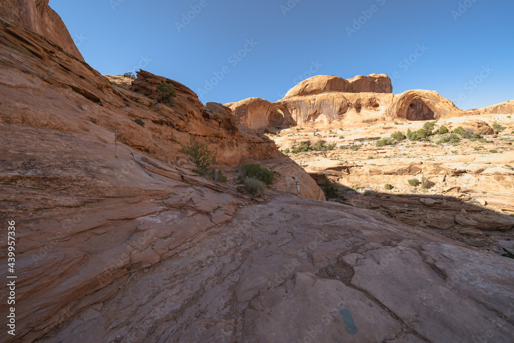 Scenery along the Corona Arch trail in Moab Utah, red rock sandstone and blue sky, right before the chains section