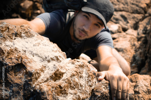 man climbing a mountain