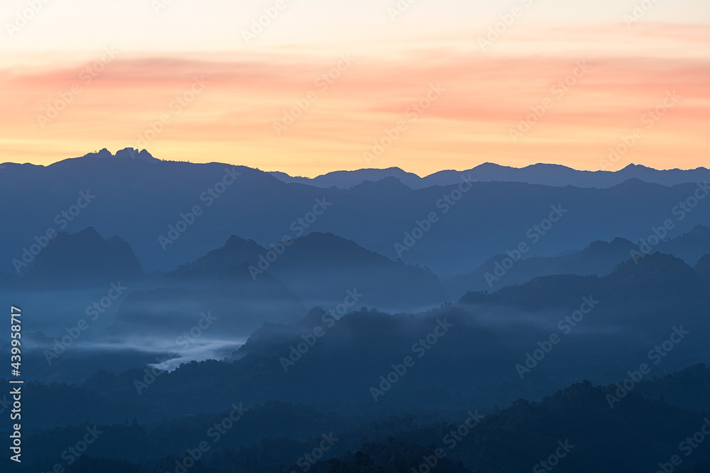 Beautiful Landscape of mountain layer in morning sun ray and winter fog at Mae Hong Son, Thailand